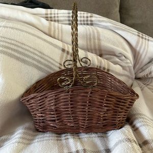 Small woven brown basket with metal brass color handle